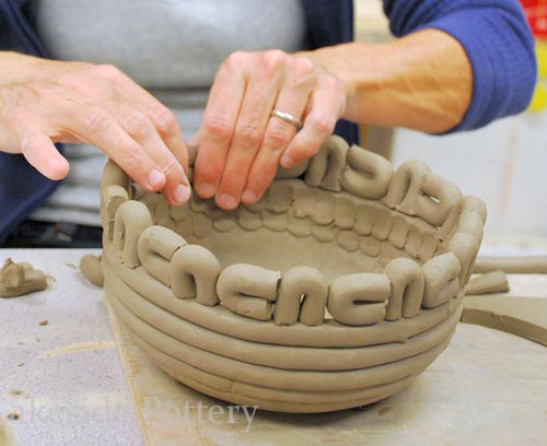 coiled pot with design