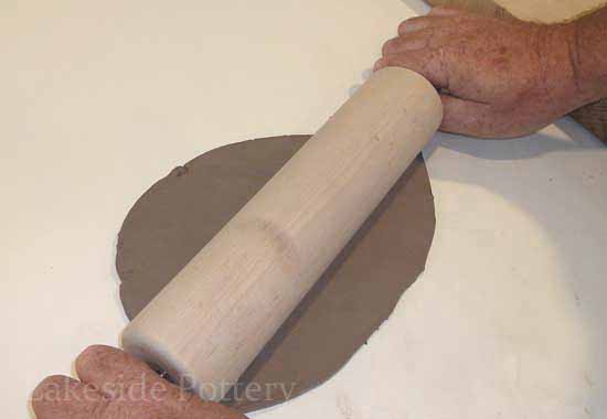 making clay flat with a rolling pin