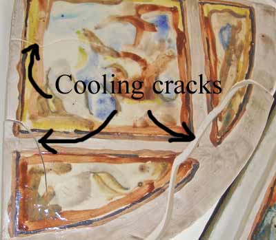 Cooling cracks on a tile sitting on a kiln shelf