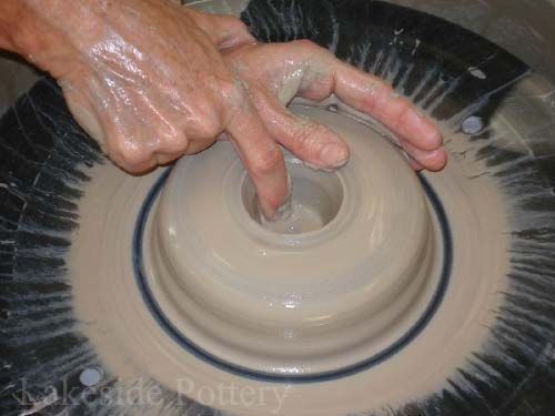 working with clay on the wheel