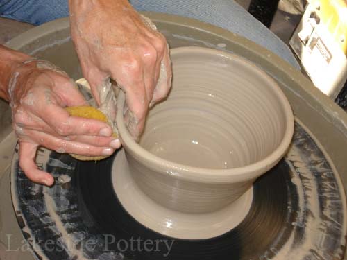 throwing pottery on the wheel