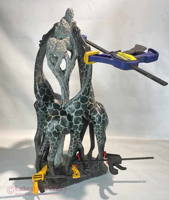 Shona stone giraffe sculpture with adhesive curing
