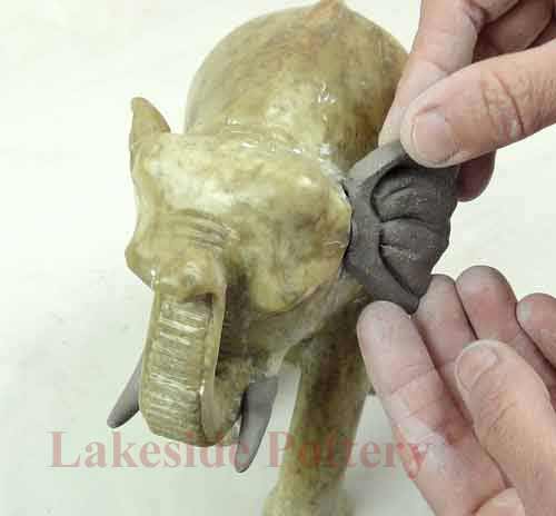 Sculpting elepahnt ear from clay