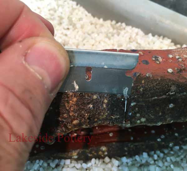 Remove excess cured epoxy with a blade