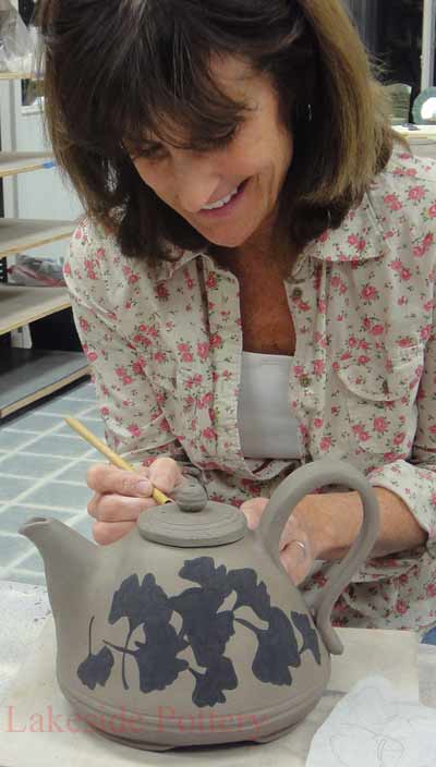 Patty painting teapot - sgraffito