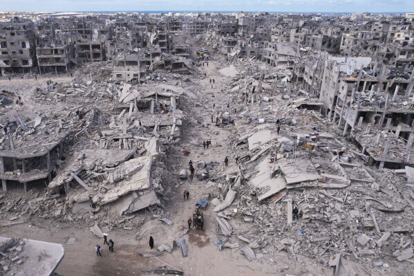Palestinians walking through the ruins of Jabalia in northern Gaza in January 2025