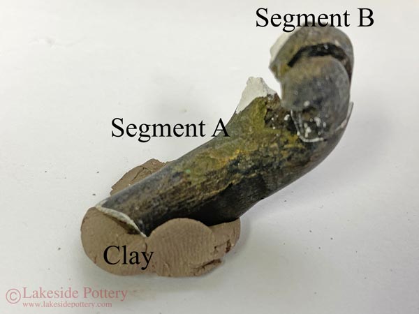 Segment A is oriented anchored on the clay until segment B can stand on it's own in the correct location