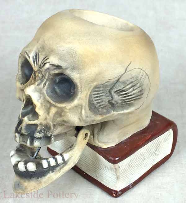 Ceramic skull with swinging jaw