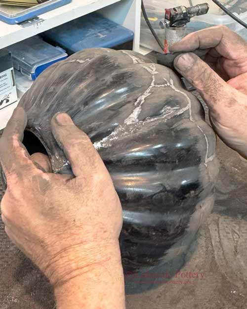 Surface refinement with 3200 grit Micro-Mesh during burnished Native American pottery restoration