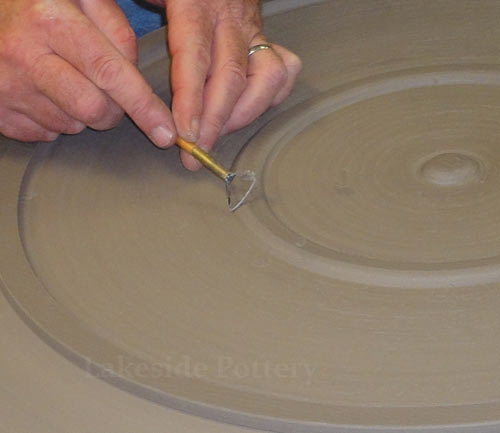 trimming a foot on a large platter
